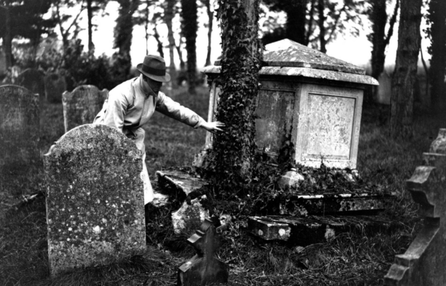 Man standing in the middle of a cemetery