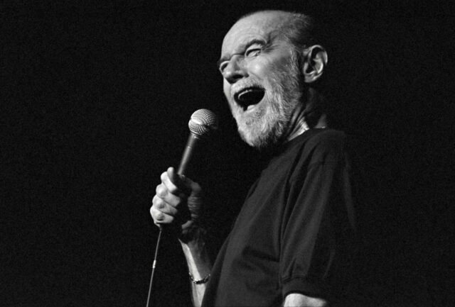 George Carlin performing on stage