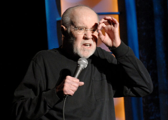 George Carlin performing on stage