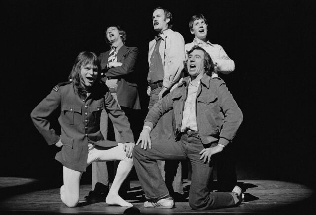 Member of Monty Python standing together on stage