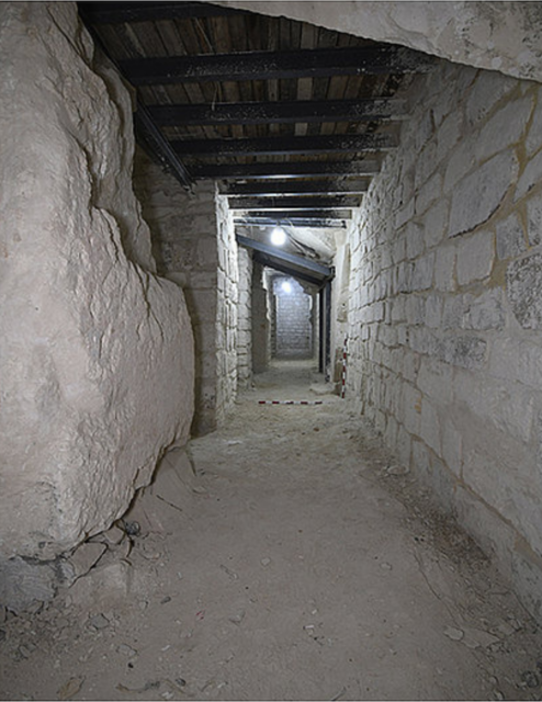 View down a stone corridor.
