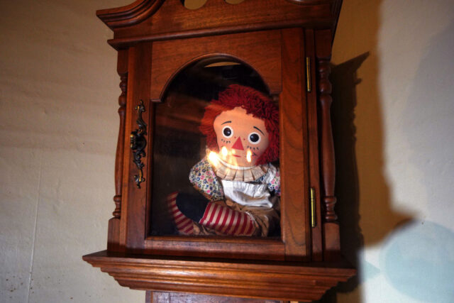 Annabelle doll on display in a glass case