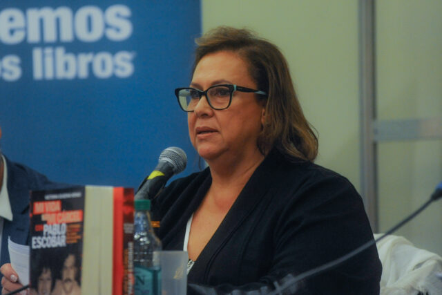 Maria Victoria Henao speaking before a microphone