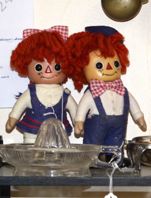 Raggedy Ann and Andy dolls on display on a table