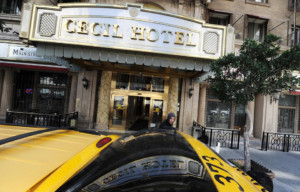 Tourist entering a taxi outside of the Cecil Hotel