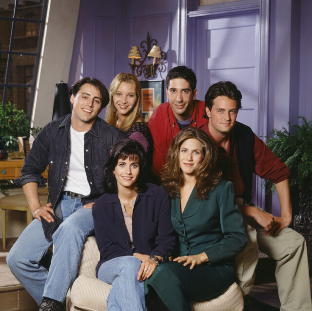 The cast of 'Friends' sitting on set.