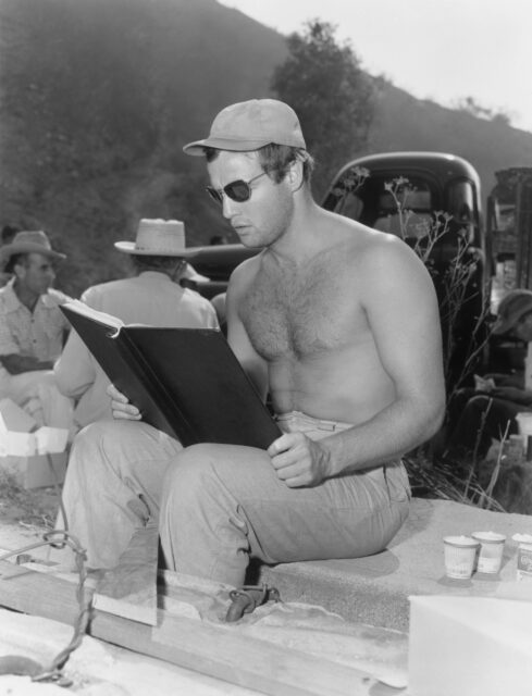 Marlon Brando reading a script shirtless.