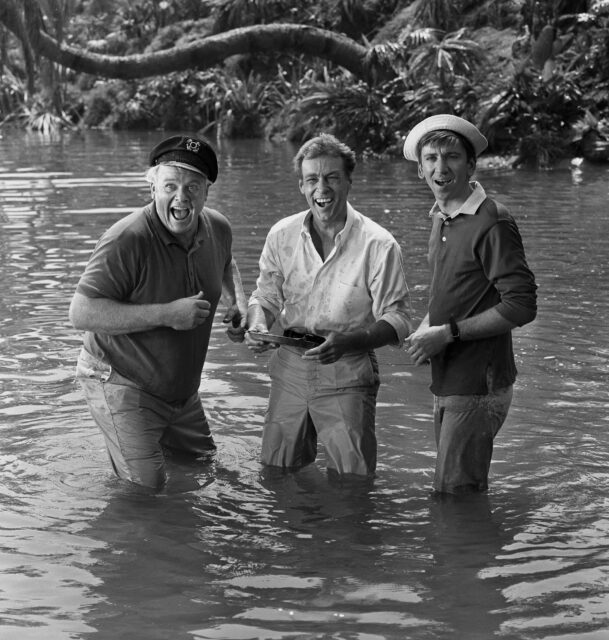 Alan Hale Jr., Russell Johnson, and Bob Denver in water to their knees in a scene from 'Gilligan's Island.