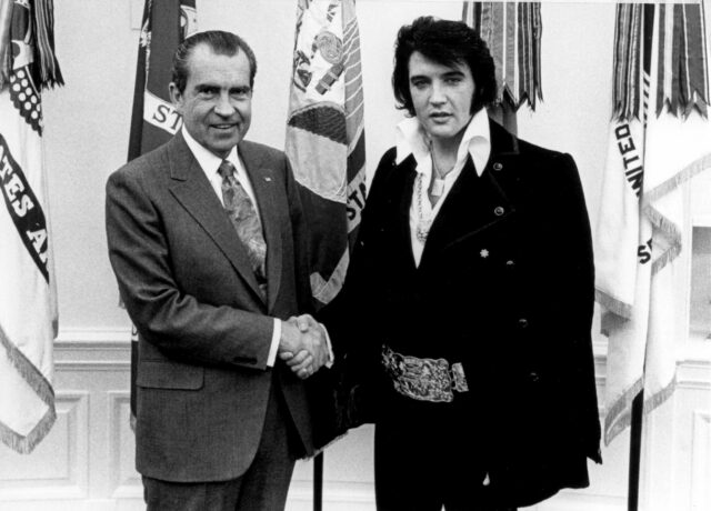 Richard Nixon and Elvis Presley shaking hands.
