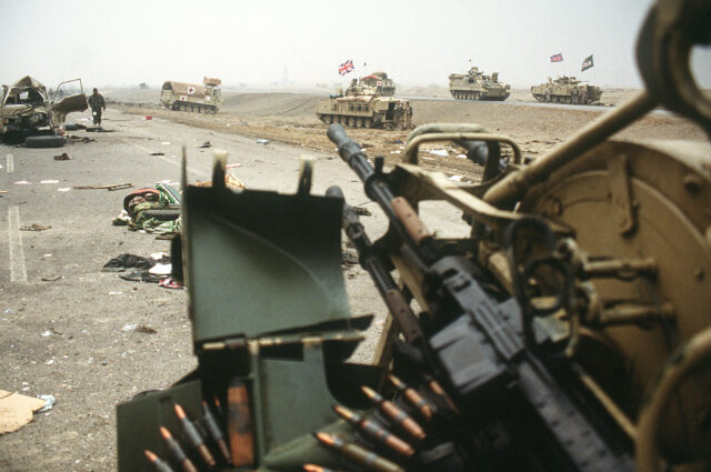 Military tanks, burned-out vehicles and debris scattered along the Highway of Death