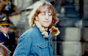 John Lennon walking down a street