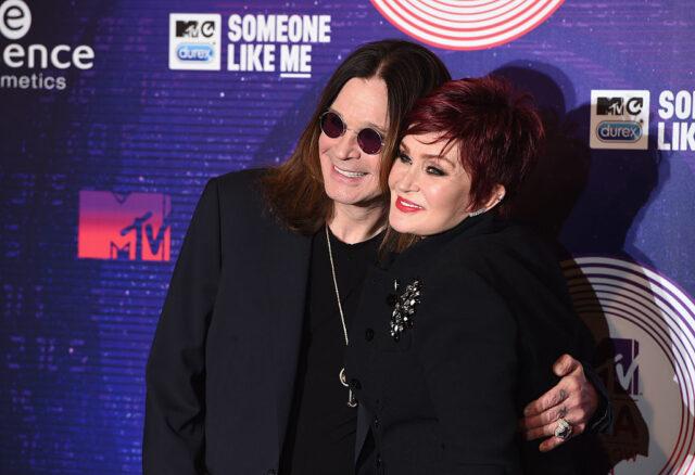 Ozzy and Sharon Osbourne standing together on a red carpet