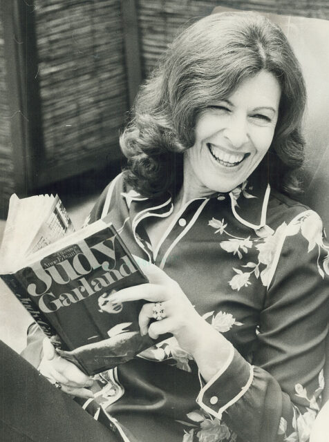 Anne Edwards holding her biography about Judy Garland