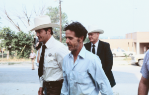 Henry Lee Lucas being walked by Texas Rangers.