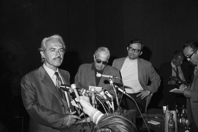 Men standing behind a press conference podium.