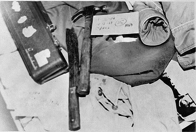 A knife and hammer in black and white picture.
