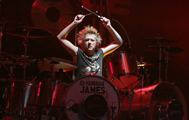 James Kottak playing the drums on stage