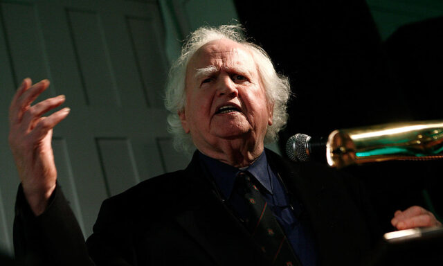 Malachy McCourt speaking into a microphone