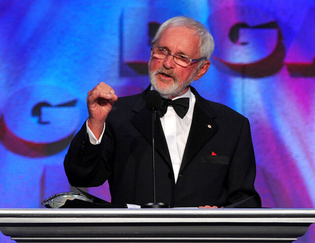 Norman Jewison speaking at a podium