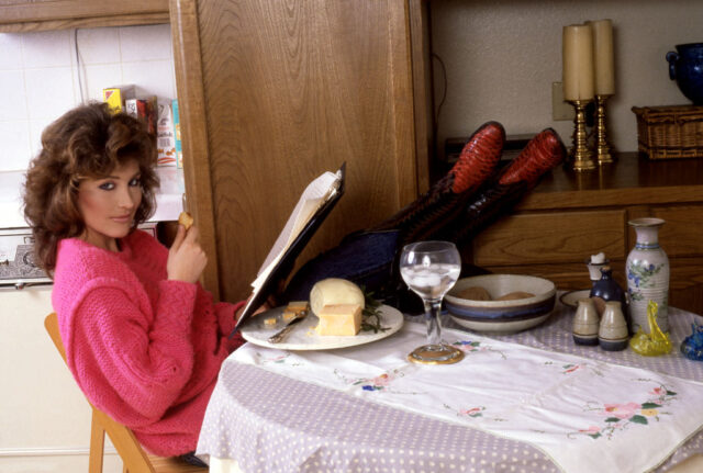 Robyn Bernard reading a book at a kitchen table