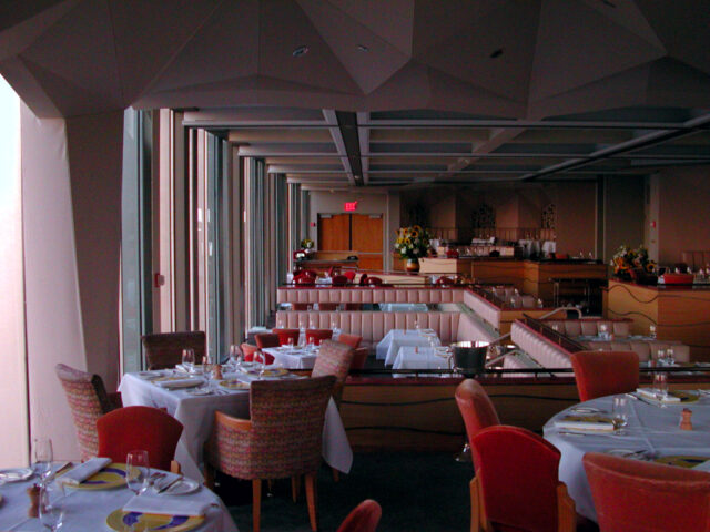 Interior of a vintage restaurant with red chairs and furniture.