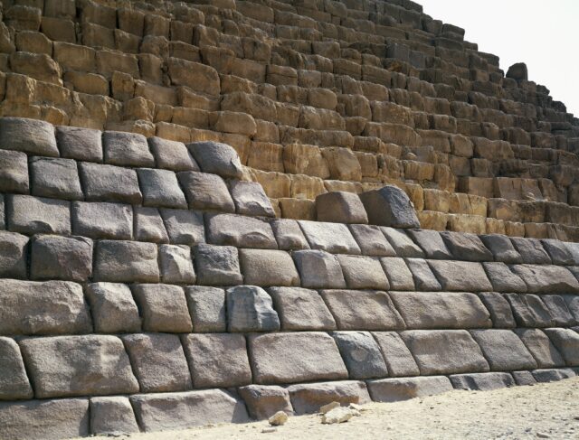Granite stones in front of a pyramid base.