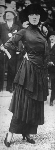 A woman poses wearing a hobble skirt.