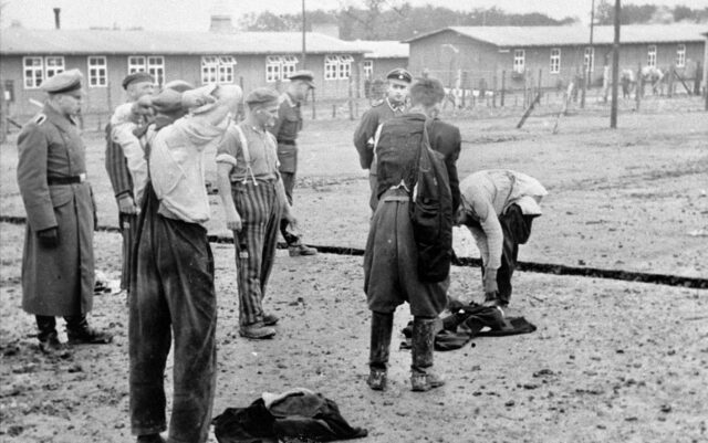 Prisoners at the camp undressing.