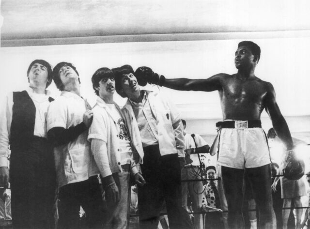 Muhammad Ali pretending to punch The Beatles.