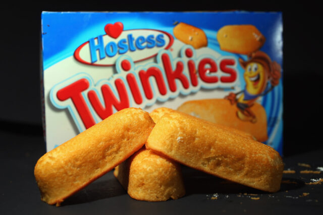 Twinkies sitting in front of their packaging.