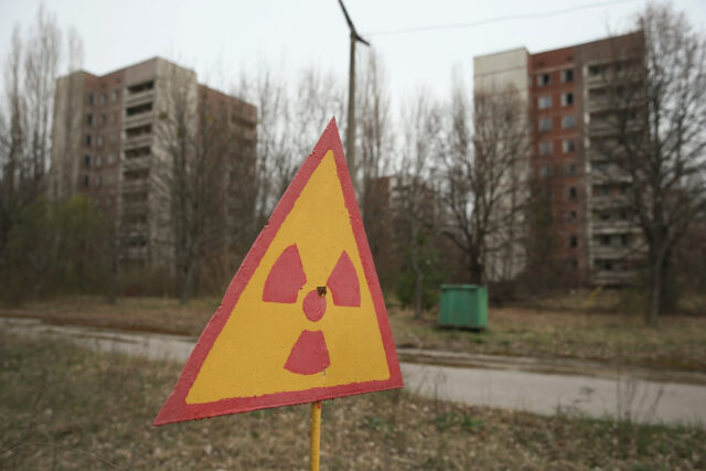 A hazard sign in front of abandoned apartments in Pripyat.