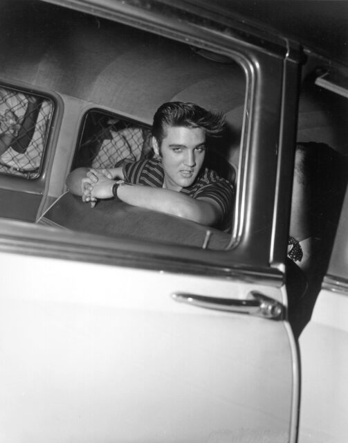 Elvis Presley in a car.