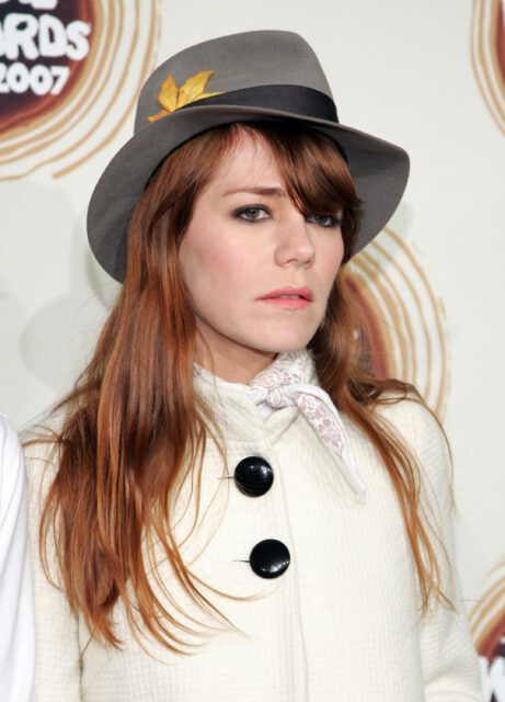 Headshot of Jenny Lewis wearing a hat.