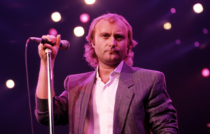 Phill Collins holding a microphone.