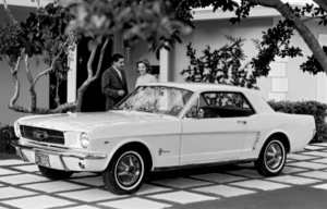 white 1964 ford mustang parked in couple's driveway