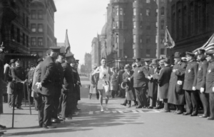 johnny miles runner of boston marathon crossing finish line in 1929