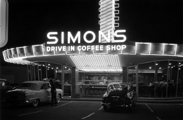 A "googie" coffee shop lit up at night.