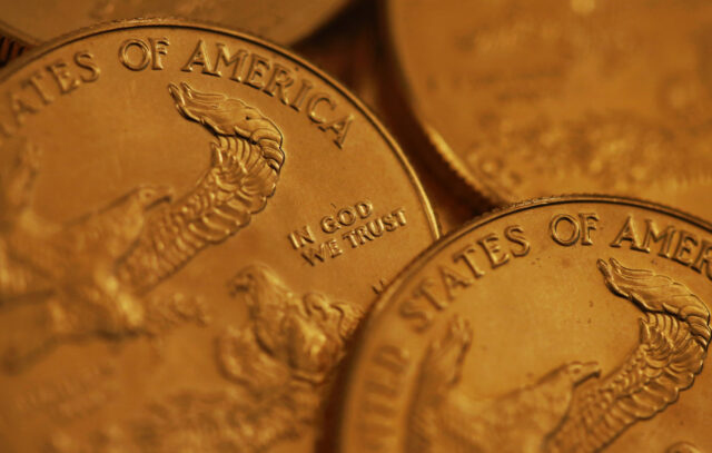 close up of US gold coins with text 'in god we trust'