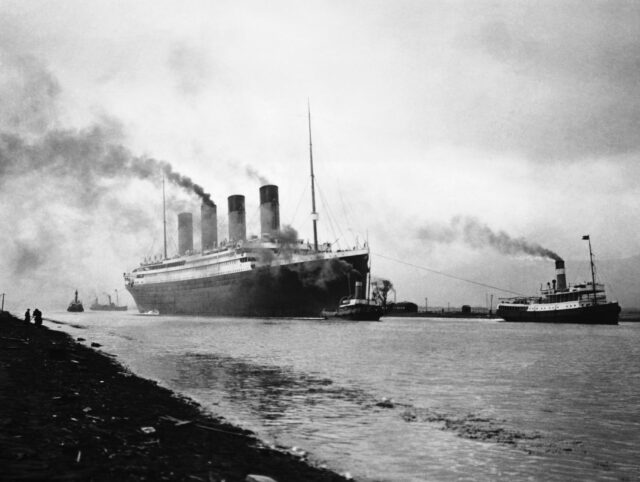 RMS Titanic being towed to sea by tugboats