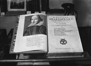 antique copy of shakepeare's folio open to page with photo of him