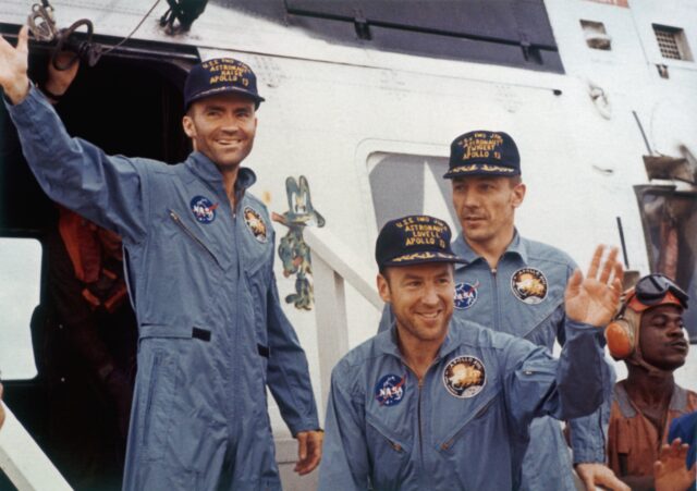 apollo 13 astronauts waving for photos after returning safely from mission