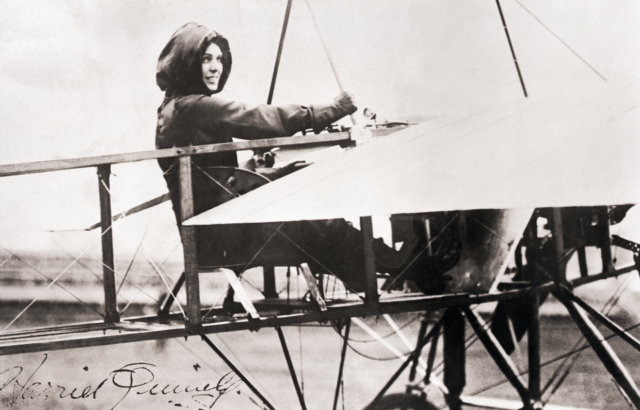 america's first woman pilot harriet quimby seated in plane on ground