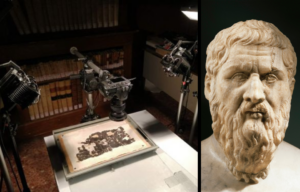 Cameras pointing to a papyrus on a table, a bust of Plato.
