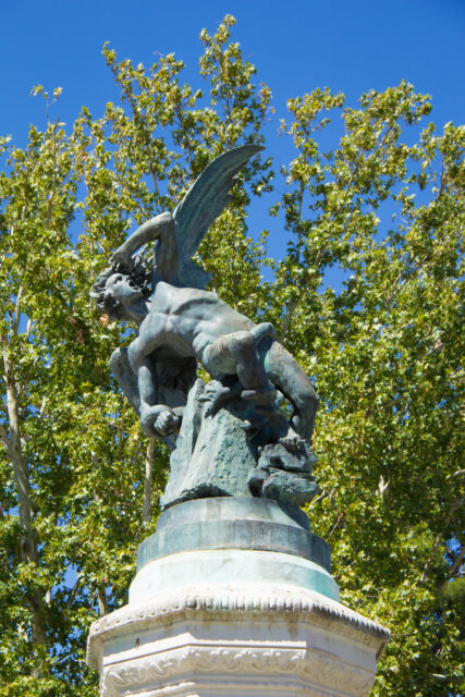 The statue of Lucifer at the top of the Fuente del Ángel Caído.