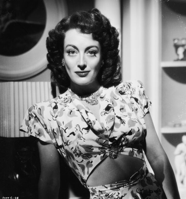 joan crawford dressed in character on set of Mildred Pierce