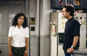 Julia Louis-Dreyfus and Jerry Seinfeld looking at one another on 'Seinfeld'