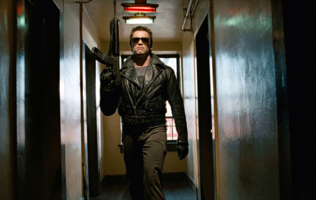 Arnold Schwarzenegger walking down a hallway as "The Terminator"