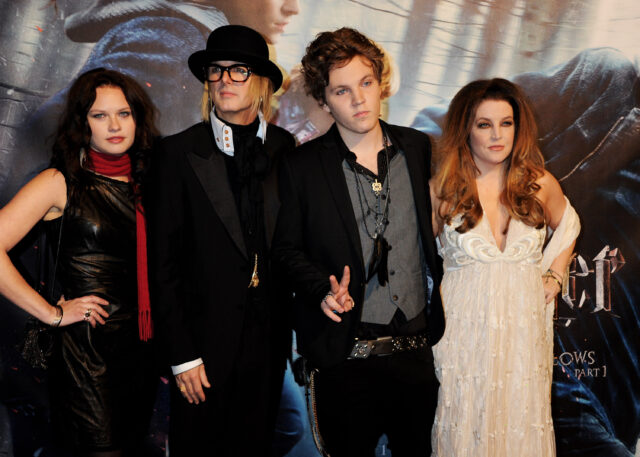 Michael Lockwood, Benjamin Keough, Lisa Marie Presley and an unidentified woman standing on a red carpet